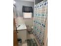 Bathroom featuring a vanity with a marble countertop, a neutral color scheme, and a shower with patterned curtain at 116 E Palm Way, Edgewater, FL 32132