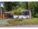 Cozy bungalow with carport and mature palm trees in a well-maintained yard at 12 N Forest Ave, Orlando, FL 32803