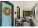 Charming front porch featuring a swing, a comfortable chair, and a colorful door at 12 N Forest Ave, Orlando, FL 32803