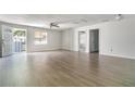 Open living room with neutral walls, light wood flooring, and an airy ambiance at 1506 37Th St, Orlando, FL 32839