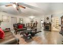 Open-concept living area with new flooring, a fireplace, and elegant dining set at 1506 37Th St, Orlando, FL 32839