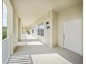 Wide hallway with bright natural light leads to unit 303 with white door and sconce at 1630 Common Way Rd # 303, Orlando, FL 32814