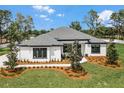 Beautiful home featuring a landscaped yard and dark trim windows at 18026 Reynolds Pkwy, Orlando, FL 32833