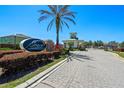 The gated community features a lush landscape, stone accents, and a secure entrance for residents at 1918 Marabou Dr, Davenport, FL 33896