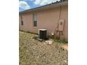 Exterior side view of the home with an air conditioning unit at 220 Abbotsbury Dr, Kissimmee, FL 34758