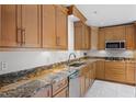 Updated kitchen featuring custom cabinetry, granite countertops, and stainless steel appliances at 2311 Huron Trl, Maitland, FL 32751