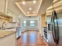 Bright kitchen with granite countertops, stainless steel appliances, and a cozy breakfast nook with bench seating at 241 Churchill Ct, Kissimmee, FL 34758