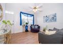 Bright living room features wood floors, ceiling fan and a sunny window with modern furniture at 4011 Venetian Bay Dr # 103, Kissimmee, FL 34741