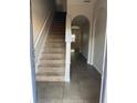 Inviting entryway with tile flooring and carpeted staircase leading to the upper level at 4126 Hedge Maple Pl, Winter Springs, FL 32708