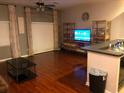 Open-concept living room with hardwood floors and ample natural light at 4126 Hedge Maple Pl, Winter Springs, FL 32708