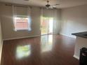 Bright living room featuring hardwood floors and sliding glass doors to outdoor area at 4126 Hedge Maple Pl, Winter Springs, FL 32708
