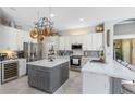 Elegant kitchen featuring marble countertops, stainless steel appliances, and a stylish kitchen island at 421 Thomez Ct, Lake Mary, FL 32746