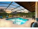 Resort style pool and jacuzzi under screened enclosure with sunning area and lush landscape views at 421 Thomez Ct, Lake Mary, FL 32746