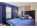 Vibrant bedroom with blue walls, Florida Gator decor, and a cozy bed at 4800 Lullaby Ln, Kissimmee, FL 34746