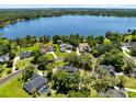 Breathtaking aerial view showcasing lakefront homes and lush landscaping on a clear, sunny day at 5297 Mill Stream Dr, St Cloud, FL 34771