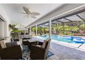 Relaxing outdoor living space featuring a covered patio with comfortable seating overlooking the sparkling pool at 5297 Mill Stream Dr, St Cloud, FL 34771