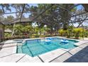Inviting screened-in pool area with spa and clear blue water, complete with a lovely, covered lanai at 5297 Mill Stream Dr, St Cloud, FL 34771