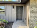 Inviting front entrance featuring a stylish front door, modern lighting and tiled entryway at 560 Garden Heights Dr, Winter Garden, FL 34787