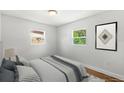 Bright bedroom with two windows and hardwood floors, adorned with a minimalist art print at 5612 Meridian Way, Orlando, FL 32808