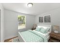 Comfortable bedroom with neutral tones, natural light, and a plush bed with decorative pillows and lamps at 5612 Meridian Way, Orlando, FL 32808
