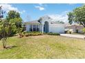 A single-Gathering home featuring manicured landscaping, a two-car garage, and inviting curb appeal at 5815 Pine Grove Run, Oviedo, FL 32765