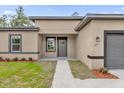 Inviting home entrance with a well-kept lawn, pathway, and complementary colors, adding curb appeal at 601 Marion Oaks Blvd, Ocala, FL 34473