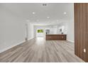 Bright, open-concept living room featuring sleek flooring and a modern accent wall, seamlessly connected to the kitchen at 601 Marion Oaks Blvd, Ocala, FL 34473