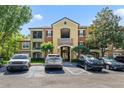 Exterior view of building with colorful painted facade and ample parking for residents and guests at 725 Crest Pines Dr # 422, Orlando, FL 32828
