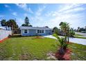 Inviting home with vibrant landscaping, new driveway, and coastal charm under a sunny sky at 8 Palm Dr, Ormond Beach, FL 32176