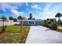 Charming single-story home features a freshly painted exterior, new driveway, and landscaping at 8 Palm Dr, Ormond Beach, FL 32176