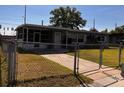 Well-maintained home with fenced yard and front walkway at 815 S Solandra Dr, Orlando, FL 32807
