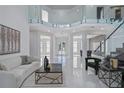 Spacious foyer with high ceilings, glass balcony, and modern finishes for a grand entrance at 10849 Emerald Chase Dr, Orlando, FL 32836