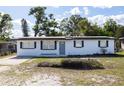 Quaint single-story home with new paint, lovely front yard, and an inviting entrance at 1313 Pine Ridge Dr, Daytona Beach, FL 32117
