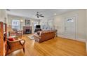 Bright living room with a brick fireplace, hardwood floors, and multiple windows at 1413 W Harvard St, Orlando, FL 32804