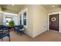 Cozy front porch with outdoor seating area and a decorative wreath on the front door at 15186 Book Club Rd, Winter Garden, FL 34787