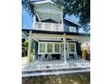 Charming two-story home with a covered front porch featuring white rocking chairs and decorative tile accents at 1521 E Harwood St, Orlando, FL 32803