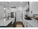 Beautiful kitchen featuring a large island with a modern faucet, stainless steel appliances and white subway tile backsplash at 15408 Lebeau Loop, Winter Garden, FL 34787
