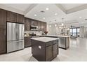 Bright kitchen boasts stainless appliances, a center island, and opens to the dining and living areas at 16300 County Road 455 # 204, Montverde, FL 34756
