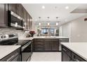 Well-equipped kitchen with a stainless steel range, sleek microwave, and plenty of counter space at 16300 County Road 455 # 204, Montverde, FL 34756