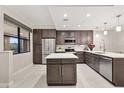 Modern kitchen with stainless steel appliances, center island, and stylish cabinets with quartz countertops at 16300 County Road 455 # 204, Montverde, FL 34756