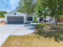 Charming single-story home featuring a gray two-car garage and a bright green front door at 194 Larkspur Ct, Kissimmee, FL 34743