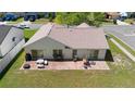 Aerial view of a home's backyard featuring a brick patio and outdoor seating area at 2645 Debany Rd, Kissimmee, FL 34744