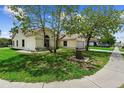 A delightful one-story home with a tidy lawn and established trees on a sunny day at 2645 Debany Rd, Kissimmee, FL 34744