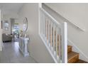 Bright, inviting staircase features hardwood steps and a white railing, adding a touch of elegance to the home's interior at 2712 Lido Key Dr, Kissimmee, FL 34747