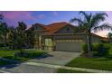 Beautiful single-story home showcasing tile roof and a well-manicured lawn with a decorative palm tree at 2721 Swoop Cir, Kissimmee, FL 34741