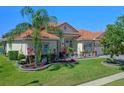 Attractive single-story home displaying colorful landscaping and a healthy palm tree at 2721 Swoop Cir, Kissimmee, FL 34741