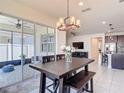 Bright dining area with a view of the outdoor patio and an elegant chandelier at 308 Buchannan Dr, Davenport, FL 33837