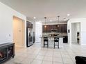 Modern kitchen with a granite island, stainless steel appliances, and sleek dark cabinetry at 308 Buchannan Dr, Davenport, FL 33837