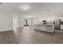 Open-concept living space featuring modern gray walls, and a modern kitchen with stainless steel appliances at 4026 Ruby Run, Haines City, FL 33844