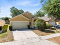 Inviting single-Gathering home features a two-car garage and well-maintained landscaping at 4579 Westgrove Way, Orlando, FL 32808